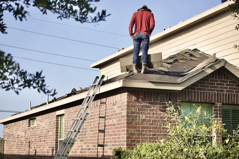 Professional roofer working on a residential roof in Victor Heights